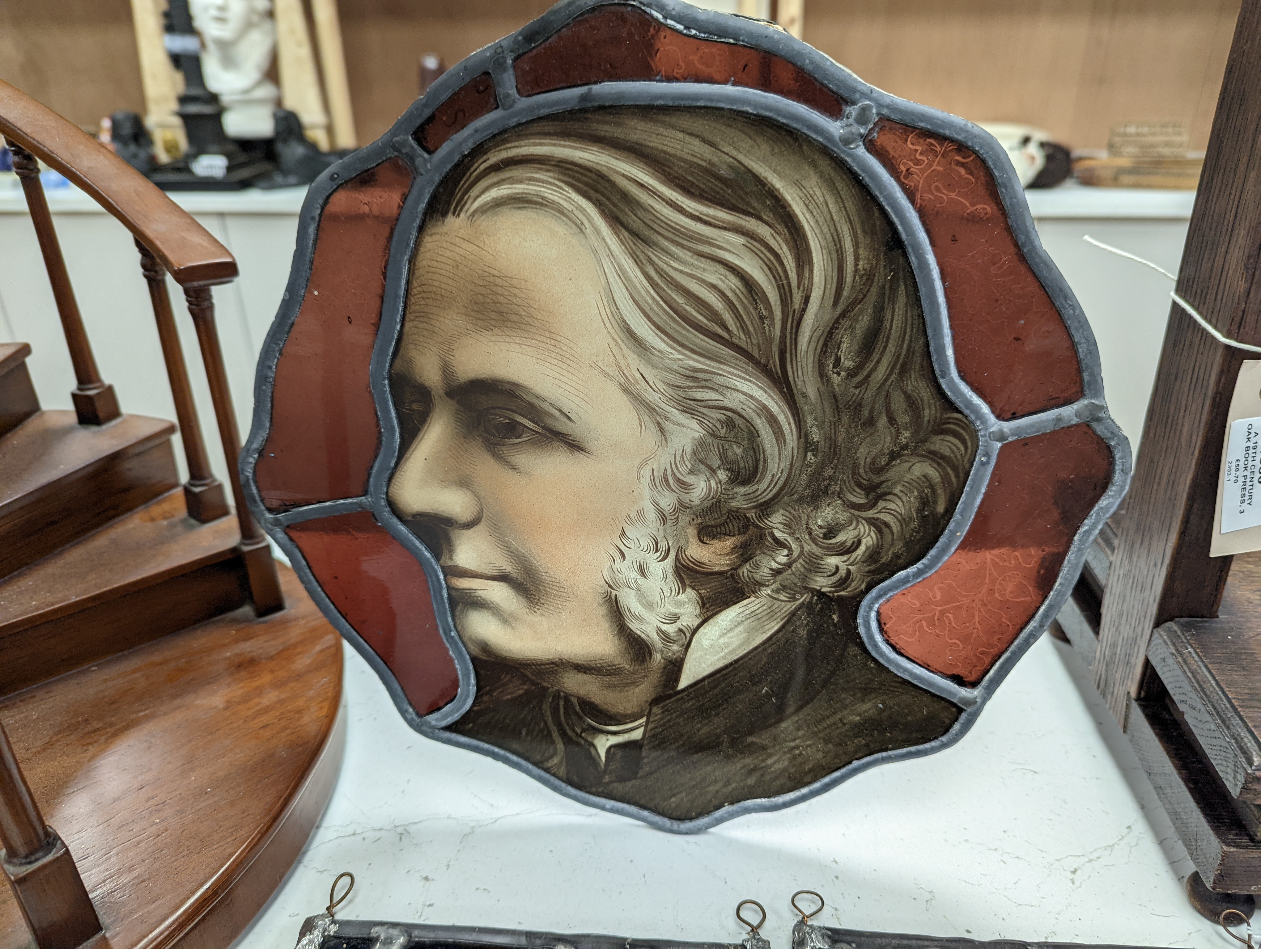 A Victorian stained glass portrait panel, two bird panels and a similar circular bird panel (4)